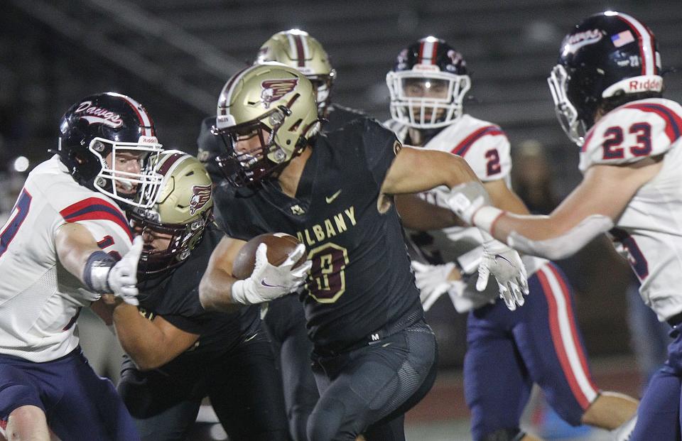 New Albany's Dylan Rosser tries to break away from Grove City's Jacob Slyth during their game at New Albany on Sept. 23.