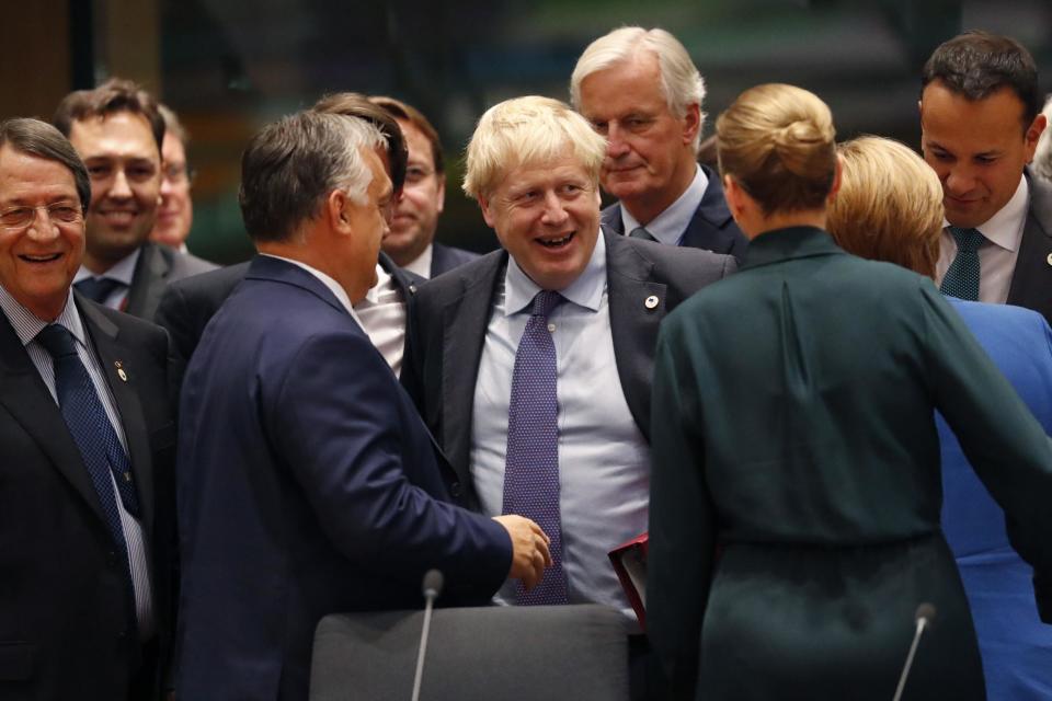 Stamp of approval: Boris Johnson, centre, speaks with German Chancellor Angela Merkel, second right, and Irish Prime Minister Leo Varadkar, right, during a round table meeting at an EU summit on Thursday (AP)