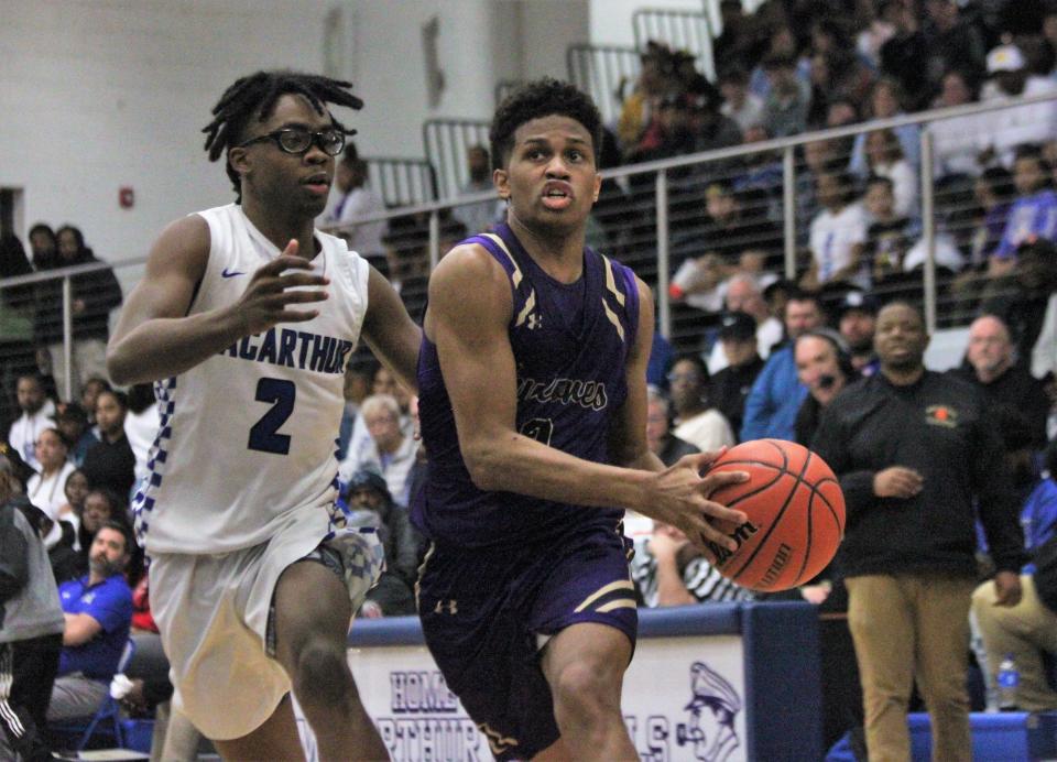 Sacred Heart-Griffin's J'veon Bardwell drives to the hoop against Decatur MacArthur's Chase Cunningham during the second half of the Class 3A Decatur MacArthur Sectional final on Friday, March 3, 2023.