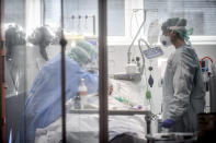 Medical personnel at work in the intensive care unit of the hospital of Brescia, Italy, Thursday, March 19, 2020. Italy has become the country with the most coronavirus-related deaths, surpassing China by registering 3,405 dead. Italy reached the gruesome milestone on the same day the epicenter of the pandemic, Wuhan, China, recorded no new infections. For most people, the new coronavirus causes only mild or moderate symptoms. For some it can cause more severe illness. (Claudio Furlan/LaPresse via AP)