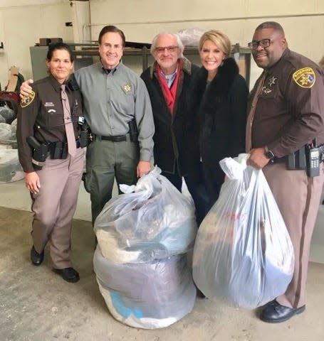 Oakland County Sheriff Michael Bouchard, second from left, gathers for a photo with volunteers at the 2019 main collection point of Bouchard's annual Coats for the Cold winter clothing drive.