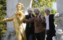 "Barock 'n' Rollers" Johann Sebastian Bass pose next to a statue of Johann Strauss in Vienna, Austria, April 24, 2015. REUTERS/Leonhard Foeger