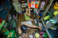 Kha Tu Ngoc and her husband Pham Huy Duc prepare for dinner in their 'micro-house' in Ho Chi Minh City. In downtown districts, families cling to postage stamp-sized plots as the city develops at breakneck pace