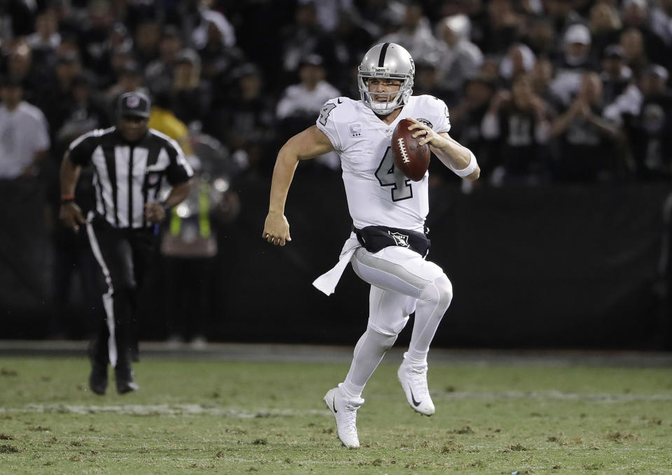 Oakland Raiders quarterback Derek Carr (4) scrambles against the Kansas City Chiefs during the second half of an NFL football game in Oakland, Calif., Thursday, Oct. 19, 2017. (AP Photo/Marcio Jose Sanchez)