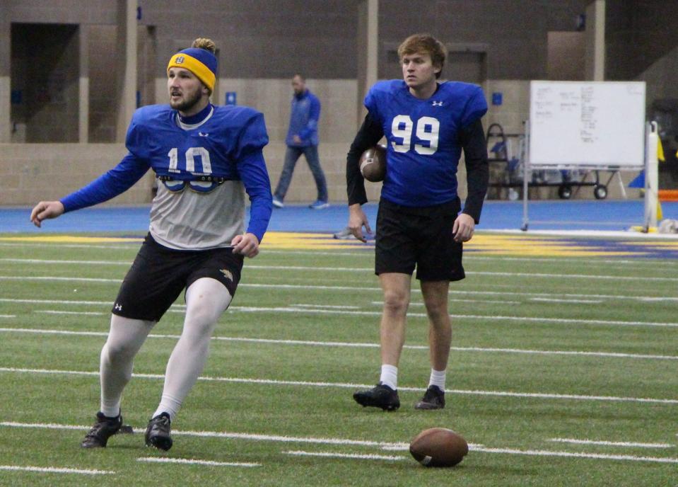 Hunter Dustman (10) and backup kicker Jack Green (99) practice onside kicks during practice Tuesday at the S-JAC.