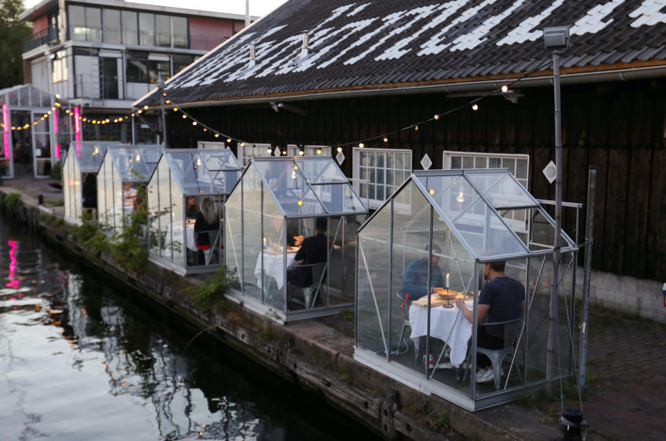 A restaurant tests servers bringing food to safe 'quarantine greenhouses' in Amsterdam, Netherlands.