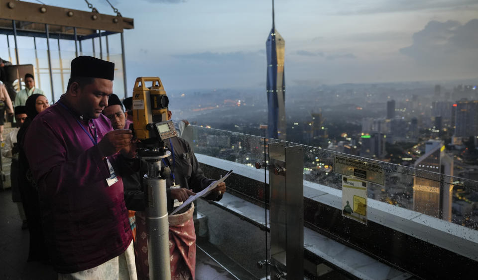 Members of the Malaysian Islamic authority perform "Rukyah Hilal Ramadan," the sighting of the new moon to determine the start of the holy fasting month of Ramadan in Kuala Lumpur, Malaysia, Wednesday, March 22, 2023. During Ramadan, Muslims worldwide marked by fasting, abstaining from foods, sex and smoking from dawn to dusk. (AP Photo/Vincent Thian)