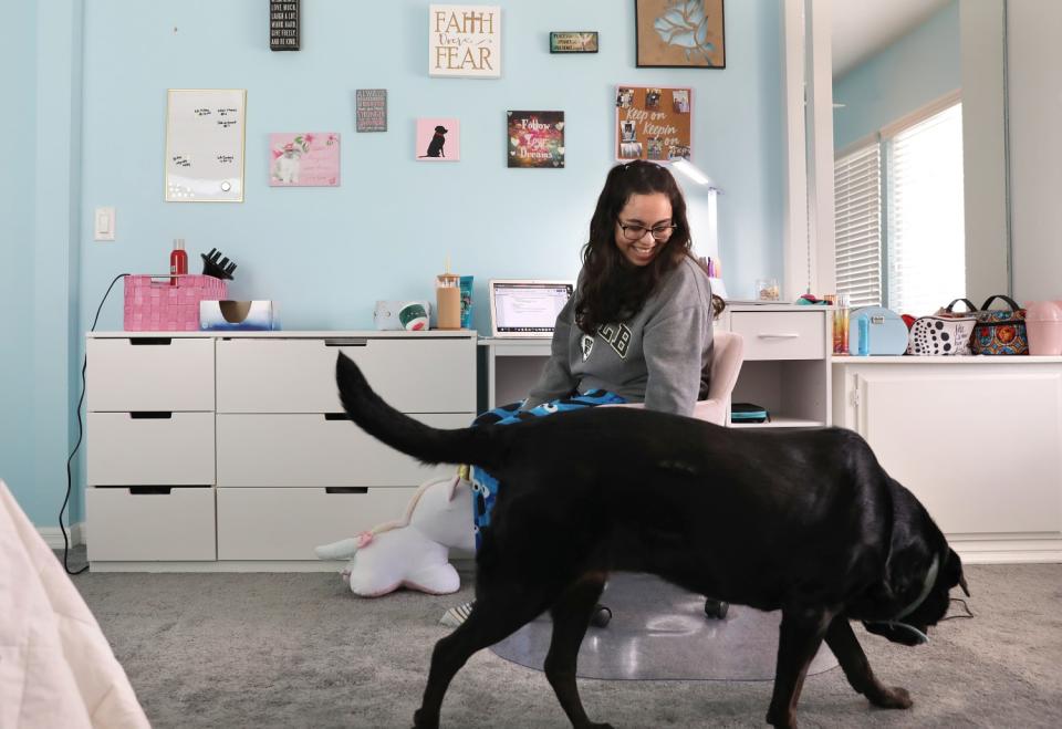 Maxime Garcia with her dog Mocha in her bedroom
