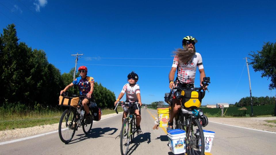 Screen capture from "Shift: The RAGBRAI Documentary": Adam Lineberry and his son, Liam, bike across Iowa during RAGBRAI 2022.