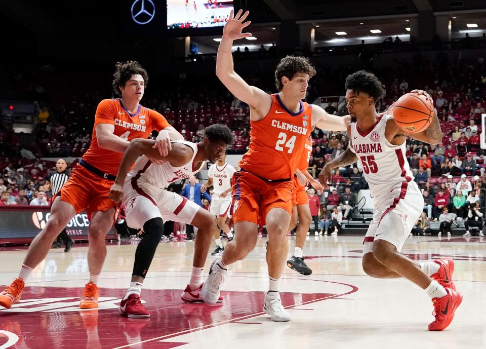 Clemson center PJ Hall (24) defends Alabama guard Aaron Estrada (55) at Coleman Coliseum.