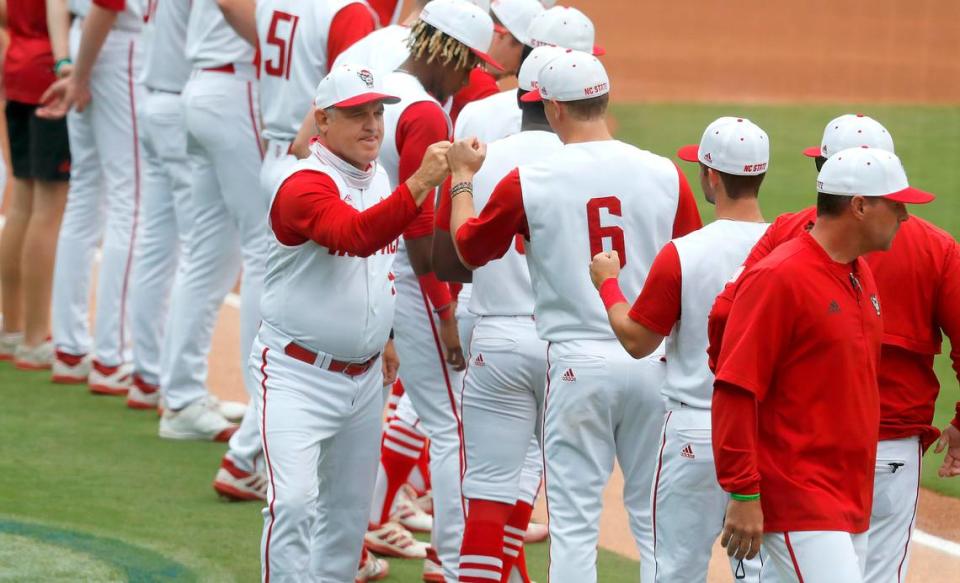 N.C. State head coach Elliott Avent greets players, including Vojtech Mensik (6) during introductions before during N.C. State’s game against Duke in the ACC Baseball Championship game at Truist Field in Charlotte, N.C., Sunday, May 30, 2021.