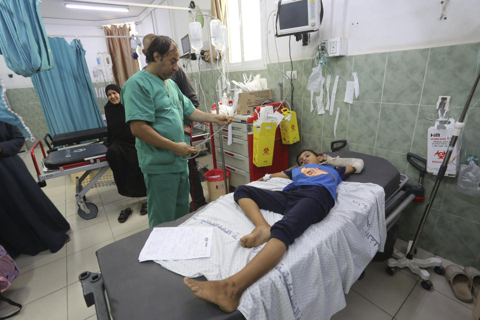 A Palestinian wounded in the Israeli bombardment of the Gaza Strip waits for treatment in a hospital in Rafah on Saturday, Oct. 28, 2023. (AP Photo/Hatem Ali)