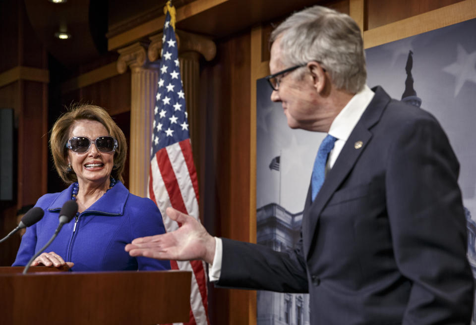 House Minority Leader Nancy Pelosi (D-Calif.) chuckles as she starts a news conference by donning dark glasses, a teasingly sympathetic gesture to Senate Minority Leader Harry Reid (D-Nev.) as he recovers from a serious injury to his right eye, suffered while exercising at his Nevada home during the holidays. (AP Photo/J. Scott Applewhite)