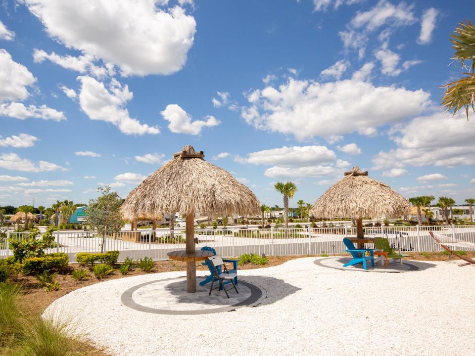 Shaded lounge areas with thatched umbrellas.