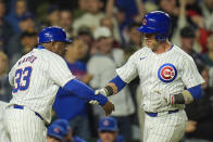 Chicago Cubs' Yan Gomes, right, grabs base coach Willie Harris after hitting a home run during the seventh inning of a baseball game against the San Diego Padres, Monday, May 6, 2024, in Chicago. (AP Photo/Erin Hooley)