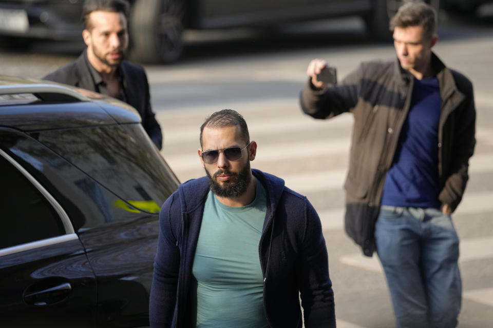 Andrew Tate and his brother Tristan arrive outside the Directorate for Investigating Organized Crime and Terrorism (DIICOT) where prosecutors examine electronic equipment confiscated during the investigation in their case, in Bucharest, Romania, Monday, April 10, 2023. (AP Photo/Andreea Alexandru)
