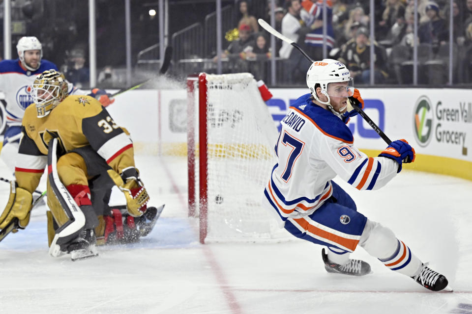 Edmonton Oilers center Connor McDavid (97) reacts after scoring against Vegas Golden Knights goaltender Adin Hill (33) during the first period of an NHL hockey game Tuesday, Feb. 6, 2024, in Las Vegas. (AP Photo/David Becker)