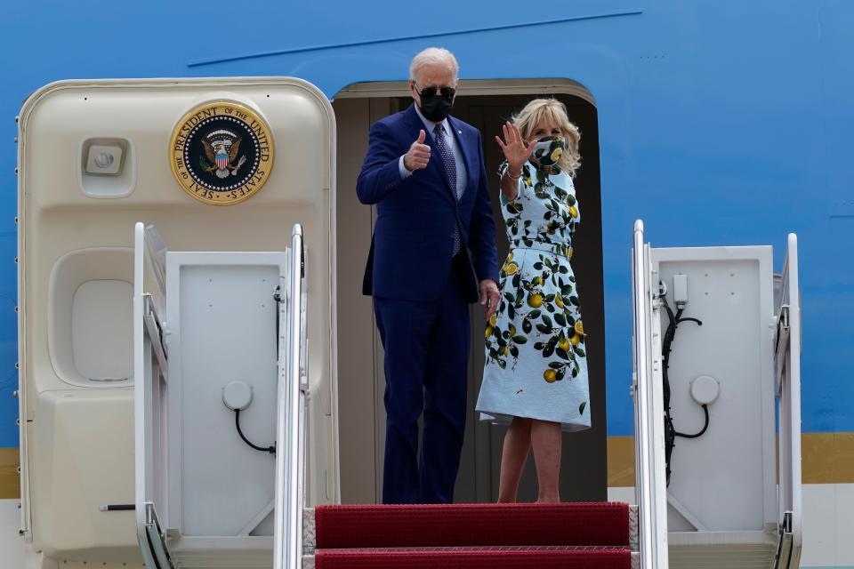 President Joe Biden and first lady Jill Biden wave from the top of the steps of Air Force One at Joint Base Andrews in Maryland.