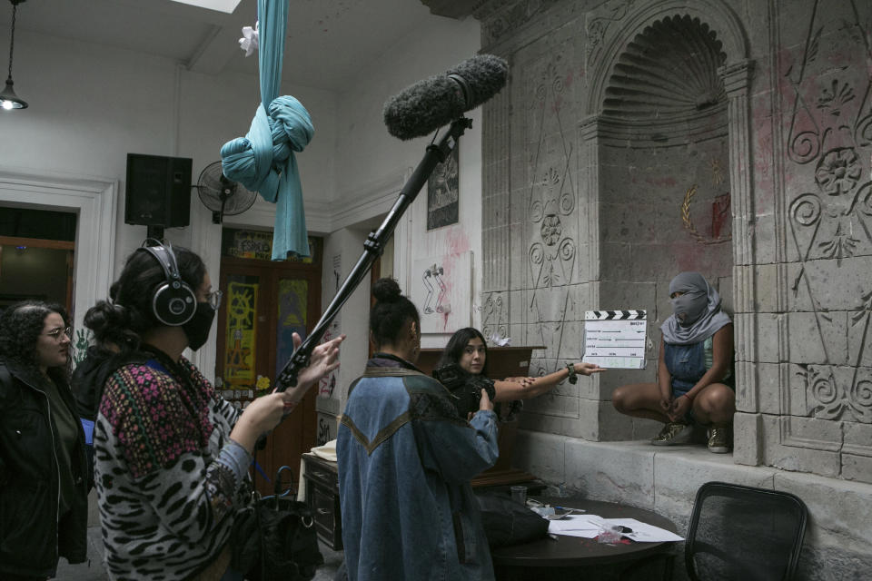 A 10-year-old victim of sexual abuse, who keeps her face covered to hide her identity, poses for an all-female documentary crew from “Las Rudas Film” inside the Mexican Human Rights Commission (CNDH) where she has been living with her mother, also a victim of sexual abuse when she was a child after women’s rights activists occupied the building and turned it into a refuge almost three months prior in Mexico City, Tuesday, Nov. 17, 2020. The girl’s mother Erika Martinez said she filed a complaint three years ago with the Prosecutor for Sexual Crimes after her daughter was abused when she was just 7 by her brother-in-law, but that he remains free. (AP Photo/Ginnette Riquelme)