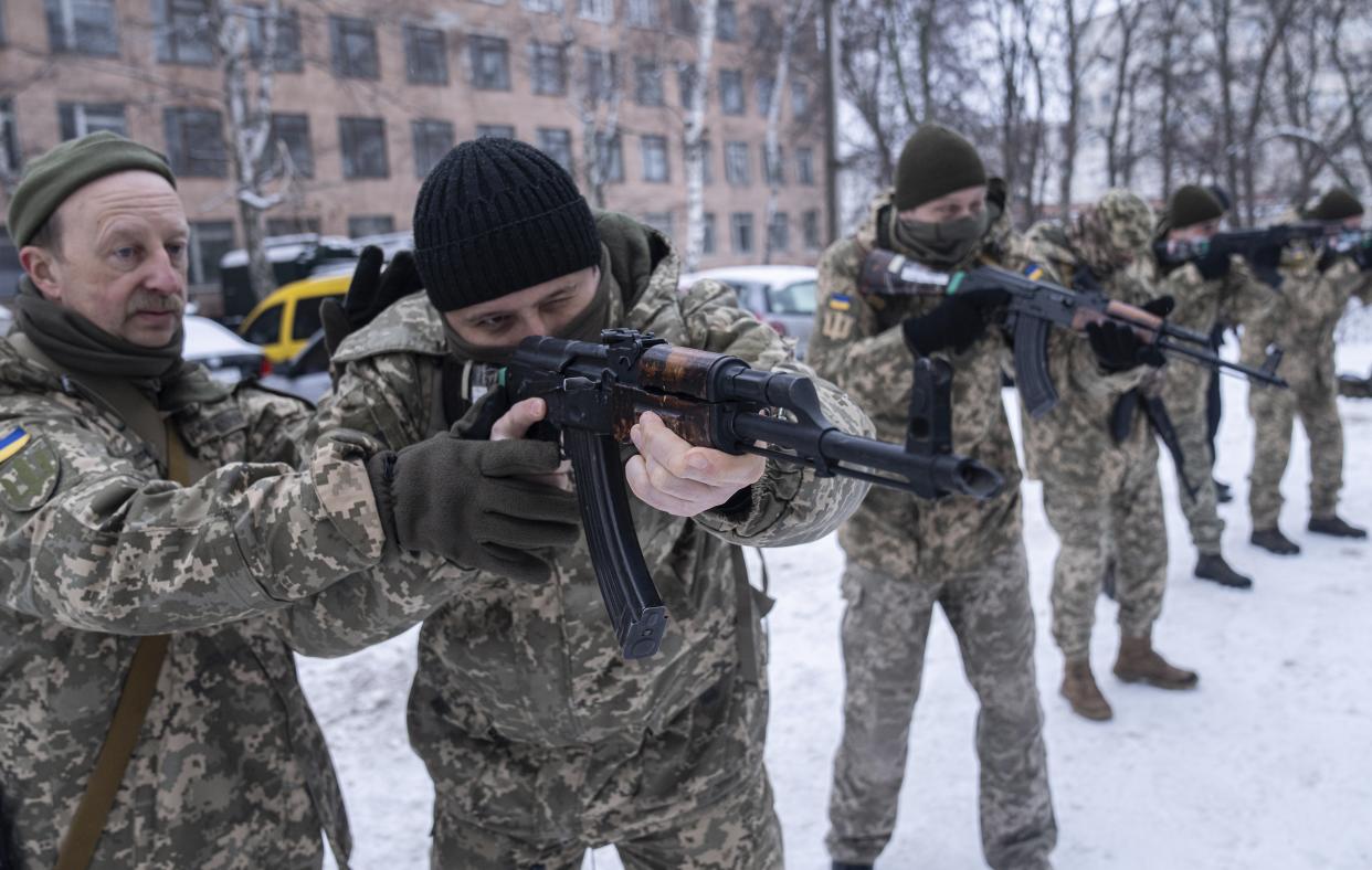 FILE - Members of Ukraine's Territorial Defense Forces, volunteer military units of the Armed Forces train, in Kharkiv, Ukraine, Saturday, Jan. 29, 2022. As the West sounded the alarm about the Kremlin ordering troops into eastern Ukraine and decried it as an invasion, Russian state media painted a completely different picture — of Moscow coming to the rescue of war-torn areas tormented by Ukraine’s aggression and bringing them peace. (AP Photo/Evgeniy Maloletka)