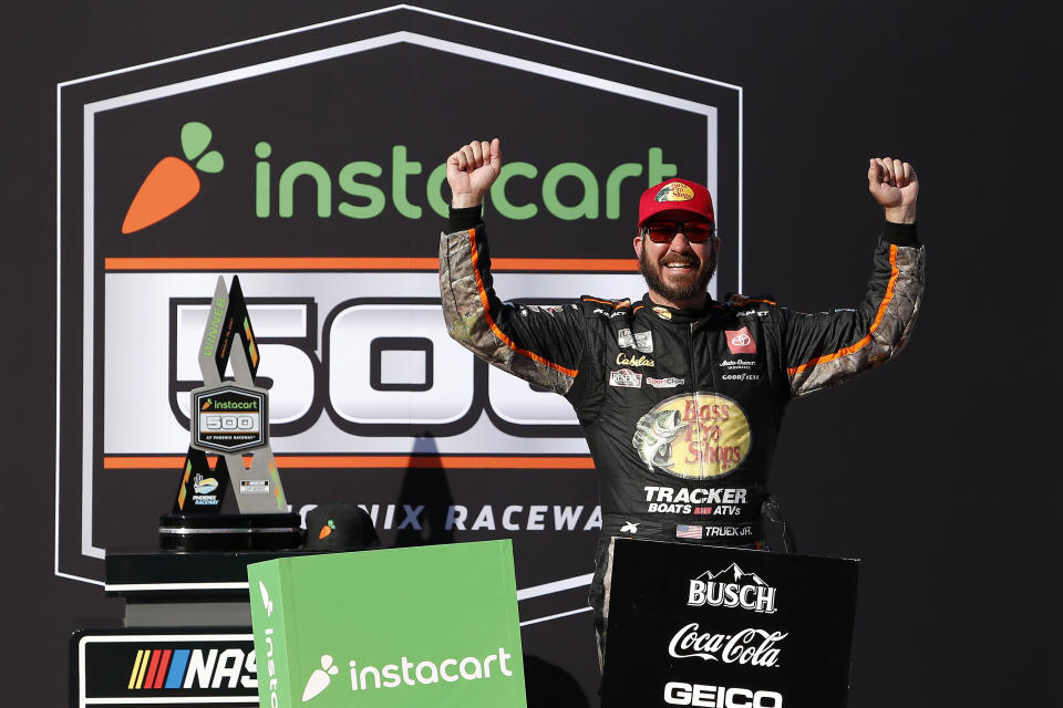 Martin Truex Jr. celebrates in Victory Lane after winning a NASCAR Cup Series auto race at Phoenix Raceway, Sunday, March 14, 2021, in Avondale, Ariz. (AP Photo/Ralph Freso)