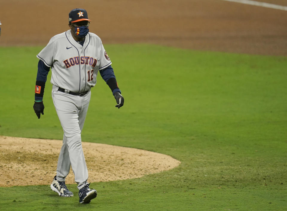 Houston Astros manager Dusty Baker walks back to the dugout after replacing pitcher Blake Taylor during the seventh inning in Game 1 of a baseball American League Championship Series, Sunday, Oct. 11, 2020, in San Diego. (AP Photo/Gregory Bull)