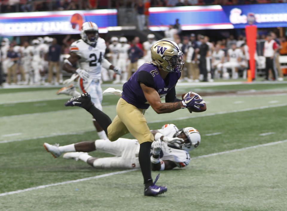 Washington wide receiver Aaron Fuller (2) makes a catch in front of Auburn defensive back Javaris Davis (13) in the first half of an NCAA college football game Saturday, Sept. 1, 2018, in Atlanta. (AP Photo/John Bazemore)