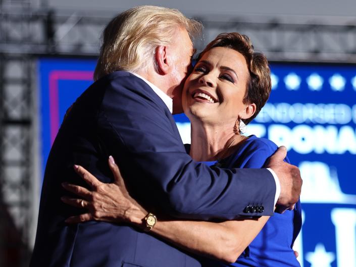 Arizona gubernatorial candidate Kari Lake embraces former President Donald Trump.