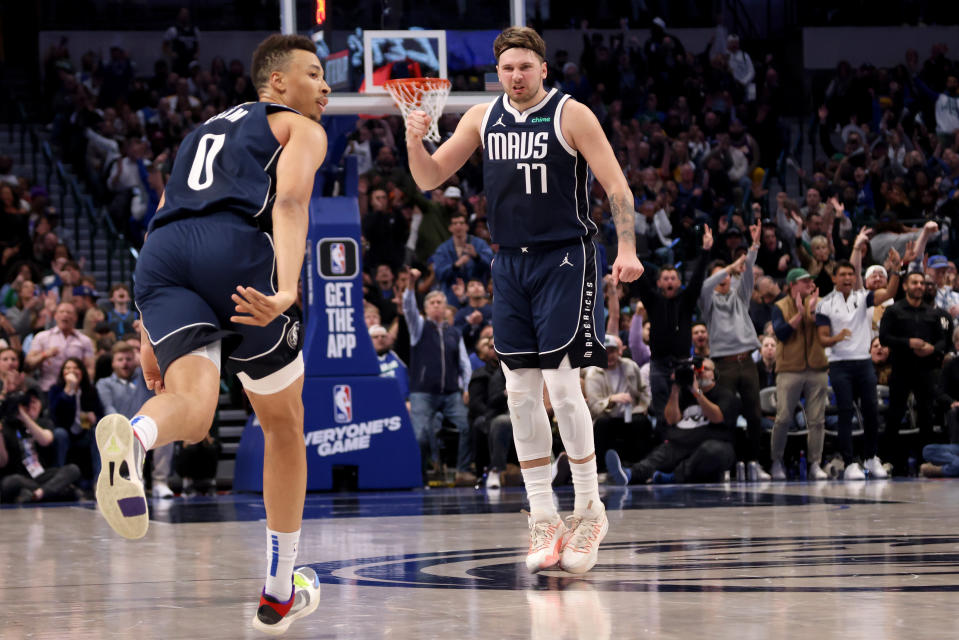 DALLAS, TEXAS - DECEMBER 12: Luka Doncic #77 of the Dallas Mavericks reacts after a basket by Dante Exum #0 of the Dallas Mavericks in the second half against the Los Angeles Lakers at American Airlines Center on December 12, 2023 in Dallas, Texas.  NOTE TO USER: User expressly acknowledges and agrees that, by downloading and or using this photograph, User is consenting to the terms and conditions of the Getty Images License Agreement. (Photo by Tim Heitman/Getty Images)