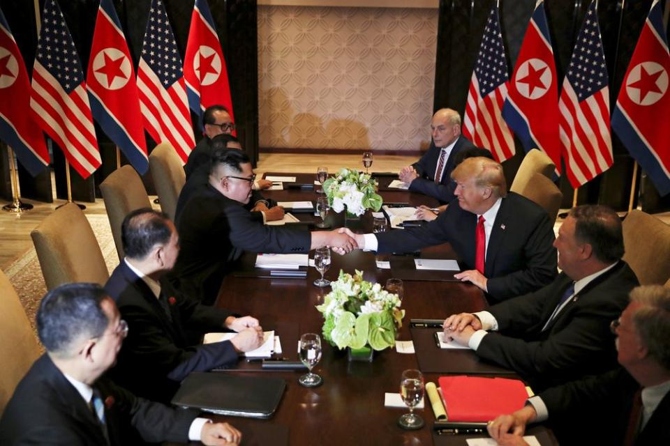 President Trump shakes hands with North Korea's Kim Jong Un before their expanded bilateral meeting in Singapore on June 12, 2018.