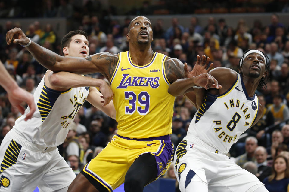 Dec 17, 2019; Indianapolis, IN, USA; Los Angeles Lakers center Dwight Howard (39) battles for rebounding position against Indiana Pacers guard Justin Holiday (8) and forward Doug McDermott (20) during the first quarter at Bankers Life Fieldhouse. Mandatory Credit: Brian Spurlock-USA TODAY Sports