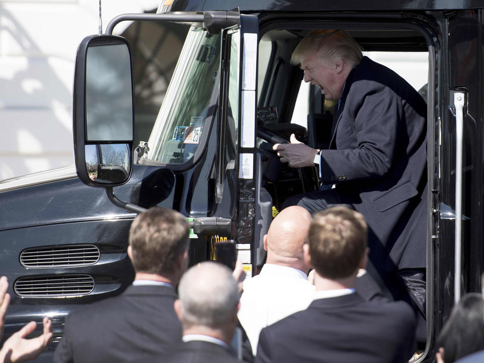 Donald Trump sits in the drivers seat of a semi-truck as he welcomes truckers and CEOs to the White House in Washington, DC, March 23, 2017: AFP/Getty Images