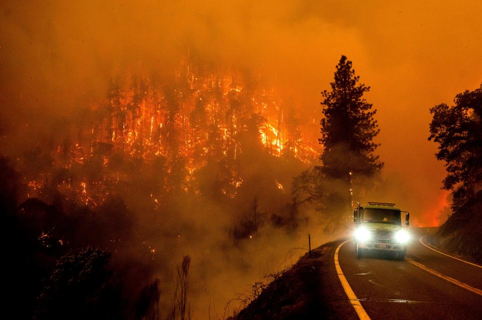 A firetruck drives along California Highway 96 as the McKinney Fire burns in Klamath National Forest on July 30, 2022.