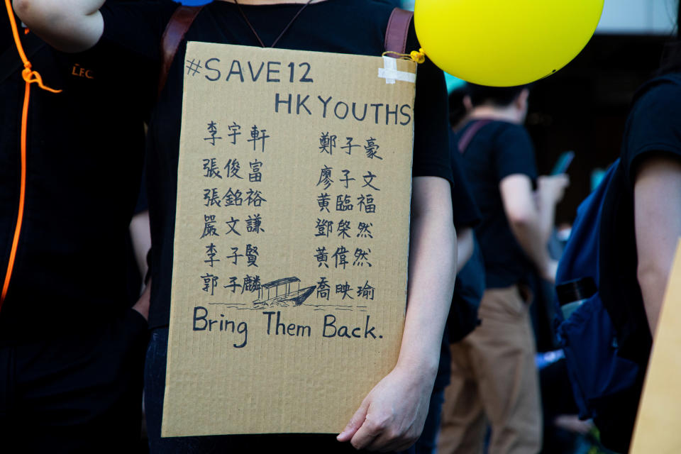 A protester holds cardboard with the names of 12 detainees during the march to demand the release of 12 Hong Kong detainees in Taipei, Taiwan, on October 25, 2020. Hundreds marched in Taiwan's capital on Sunday to demand the release of 12 Hong Kong anti-government protesters who were allegedly traveling illegally by boat to Taiwan when Chinese authorities captured and detained them in August. (Photo by Annabelle Chih/NurPhoto via Getty Images)