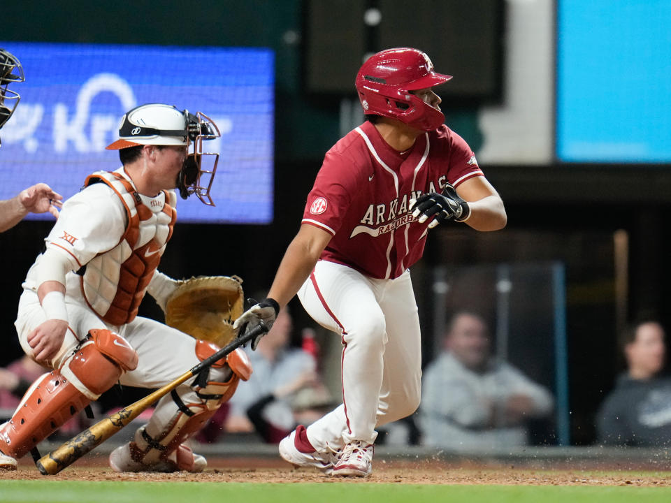 Feb 17, 2023; Arlington, TX, USA; Arkansas infielder Kendall Diggs (5) hits a two-rbi single in the seventh inning against Texas during the College Baseball Showdown at Globe Life Field. Mandatory Credit: Chris Jones-USA TODAY Sports