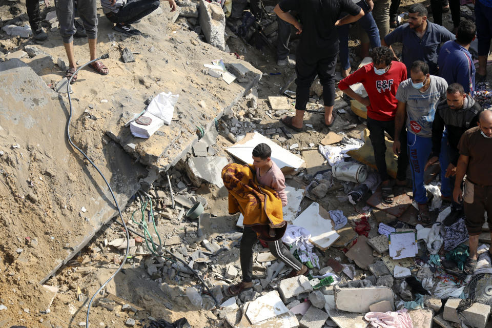 A Palestinian man carries a dead child that was found under the rubble of a destroyed building, following Israeli airstrikes in Jabaliya refugee camp, northern Gaza Strip, Wednesday, Nov. 1, 2023. In just 25 days of war, more than 3,600 Palestinian children have been killed in Gaza, according to Gaza's Hamas-run Health Ministry. The advocacy group Save The Children says more children were killed in Gaza in October 2023 than in all conflict zones around the world combined in 2022. (AP Photo/Abed Khaled)