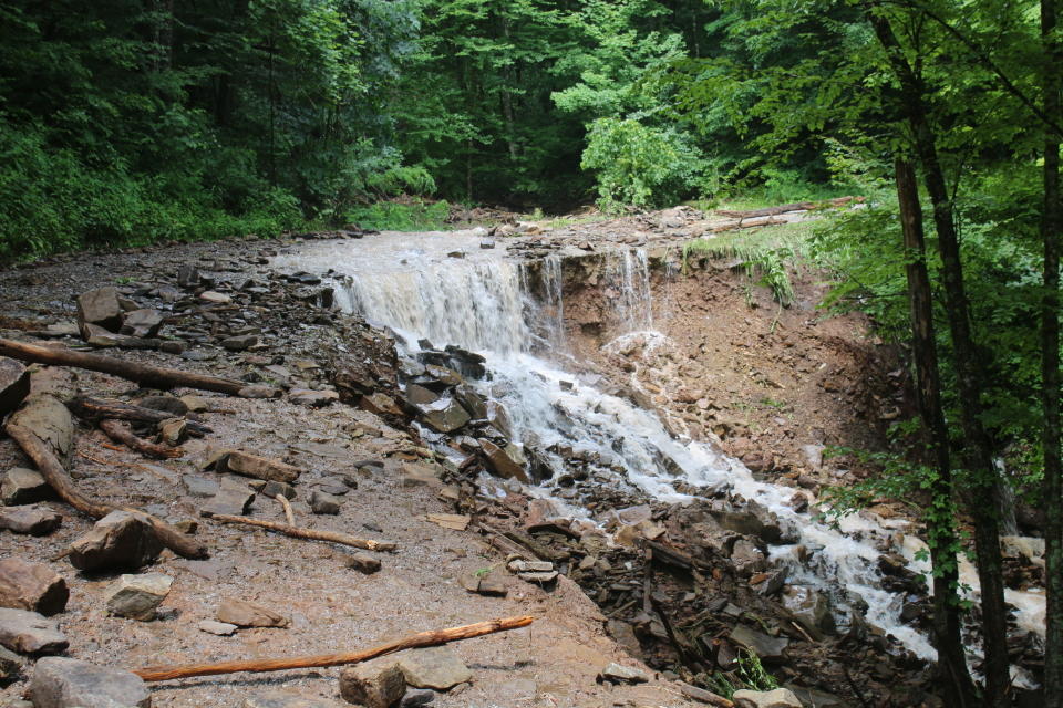 A road is washed out in the Harman area of Randolph County, W.V., Sunday, June 30, 2019. Severe thunderstorms caused flash flooding that knocked homes off their foundations and washed out roads in several mountainous counties of West Virginia, and some state lawmakers asked Gov. Jim Justice on Sunday to declare a state of emergency. (Destiny Judy/Daily Inter-Mountain via AP)