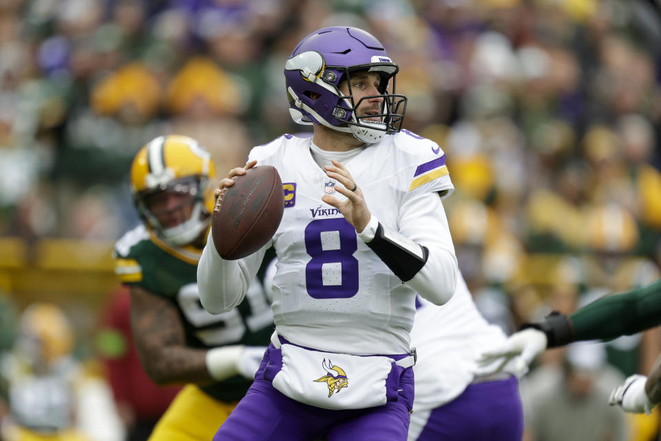 FILE - Minnesota Vikings quarterback Kirk Cousins (8) looks to pass during an NFL football game against the Green Bay Packers, Oct. 29, 2023, in Green Bay, Wis. Kirk Cousins is heading to the Falcons. Saquon Barkley is joining the Eagles. Brian Burns is going to the Giants. The first day of the NFL’s legal tampering period Monday, March 11, 2024, was a free-for-all frenzy with teams making one big move after another, highlighted by Cousins’ decision to leave Minnesota for Atlanta. (AP Photo/Matt Ludtke, File)