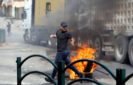 A Palestinian reacts during clashes with Israeli troops in Hebron, in the occupied West Bank October 1, 2018. REUTERS/Mussa Qawasma