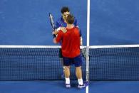 Spain's David Ferrer (top) speaks with Australia's Lleyton Hewitt after Ferrer won their second round match at the Australian Open tennis tournament at Melbourne Park, Australia, January 21, 2016. REUTERS/Jason O'Brien