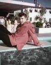 <p>Elvis Presley wears a red checkered sport coat as he reclines on the Frontier Hotel's diving board in Las Vegas in 1955. </p>