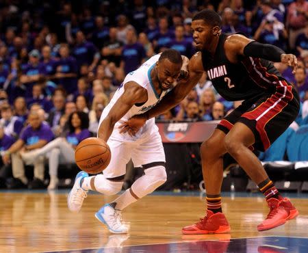 Apr 29, 2016; Charlotte, NC, USA; Charlotte Hornets guard Kemba Walker (15) moves to the basket as he is defended by Miami Heat forward Joe Johnson (2) during the first half in game six of the first round of the NBA Playoffs at Time Warner Cable Arena. Mandatory Credit: Sam Sharpe-USA TODAY Sports