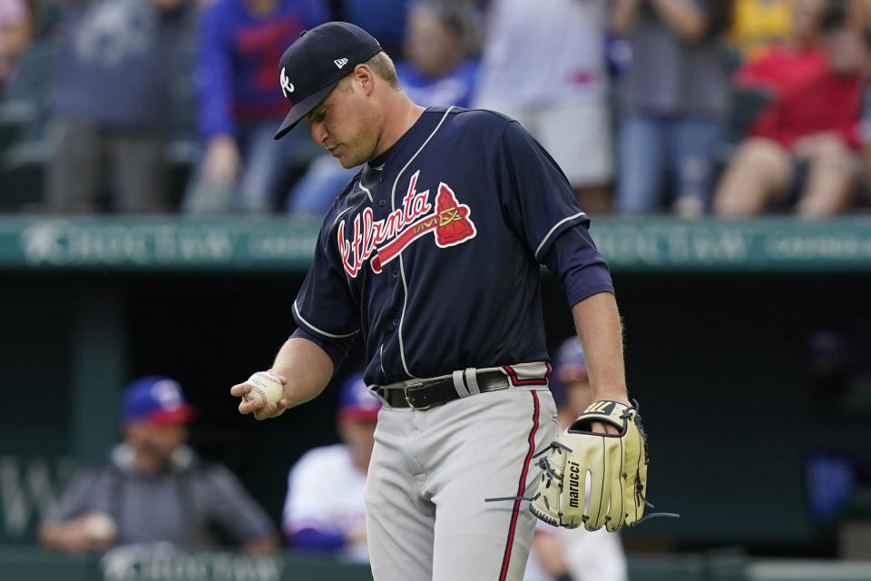 Atlanta Braves starting pitcher Bryce Elder looks at a new ball after giving up a solo home run to Texas Rangers' Corey Seager during the first inning of a baseball game in Arlington, Texas, Saturday, April 30, 2022. (AP Photo/LM Otero)