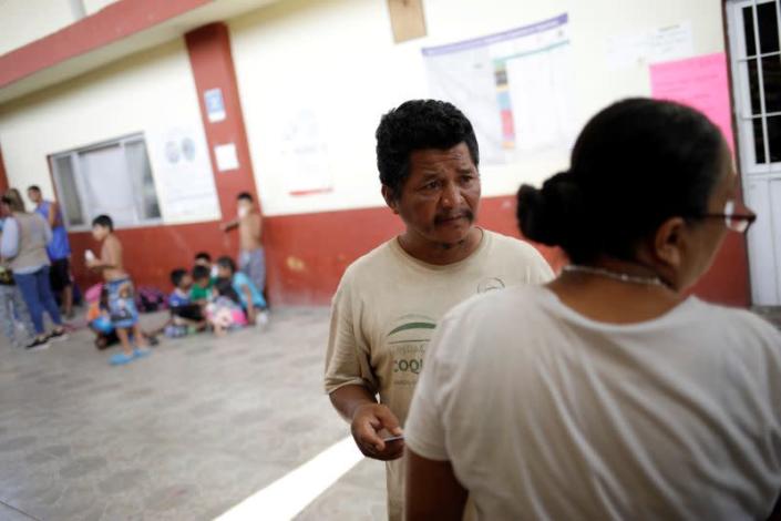 Guatemalan migrant Gomez speaks to "Jesus el buen Pastor" shelter director Martinez in Tapachula
