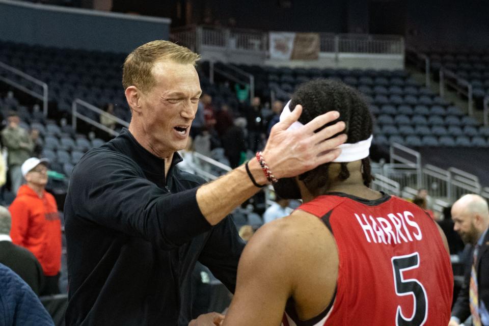 Southeast Missouri Head Coach Brad Korn celebrates with Southeast Missouri’s Chris Harris (5) following their victory over the Tennessee Tech Golden Eagles in the OVC men's championship at Ford Center on Saturday, March 4, 2023.