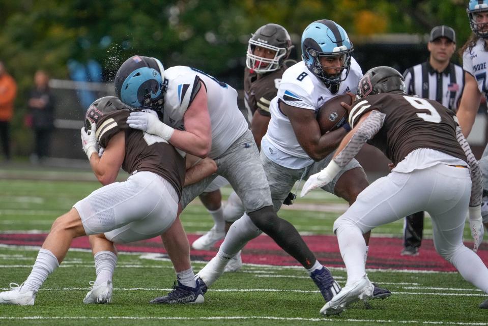URI quarterback Kasim Hill, looking for running room on this play, completed 16-of-30 passes for 222 yards and three touchdowns in the Rams victory over Brown on Saturday.