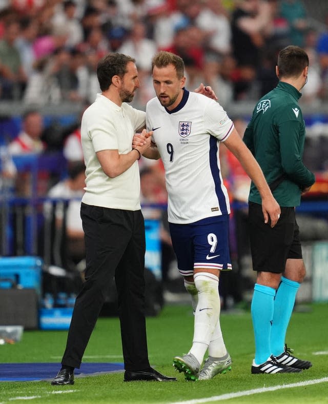 Harry Kane shakes hands with Gareth Southgate after being substituted 