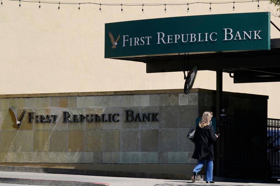 FTSE A pedestrian walks toward a First Republic Bank location in San Francisco, Tuesday, April 25, 2023. First Republic Bank's stock plunged Tuesday after it said depositors withdrew more than $100 billion during last month's crisis, with fears swirling that it could be the third bank to fail after the collapse of Silicon Valley Bank and Signature Bank. (AP Photo/Jeff Chiu)