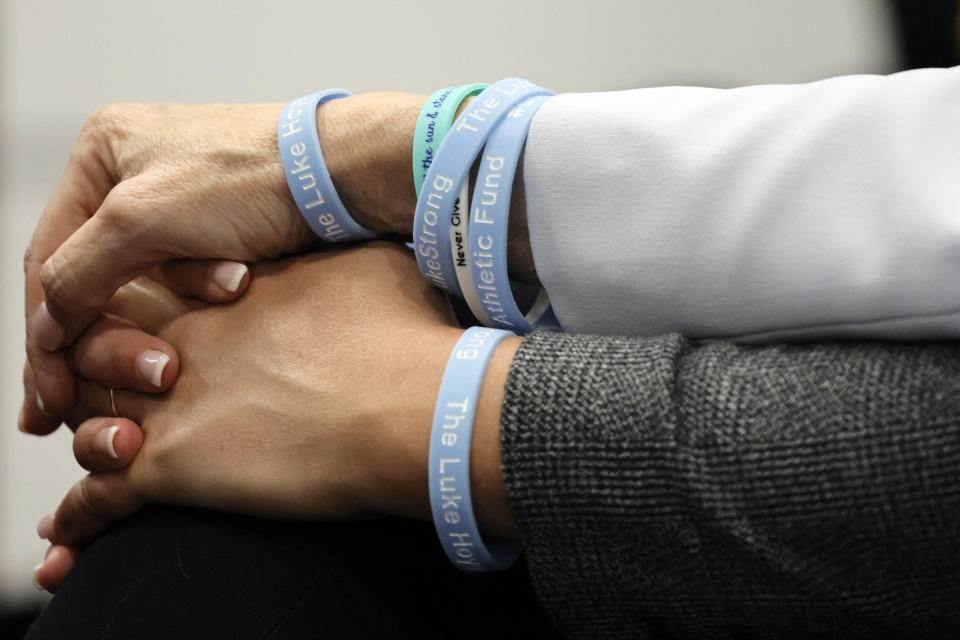 FILE - Gena and Tom Hoyer, wearing bracelets in memory of their son, Luke, hold hands during the sentencing hearing for Parkland school shooter Nikolas Cruz at the Broward County Courthouse in Fort Lauderdale, Fla., on Wednesday, Nov. 2, 2022. Luke was killed in the 2018 shootings. (Amy Beth Bennett/South Florida Sun Sentinel via AP, Pool, File)