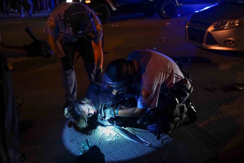 Police detain a protester for blocking traffic during a rally against racial inequality and the police shooting death of Rayshard Brooks, in Atlanta